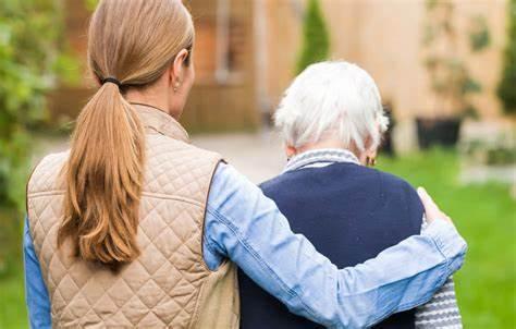 A girl holding an old man