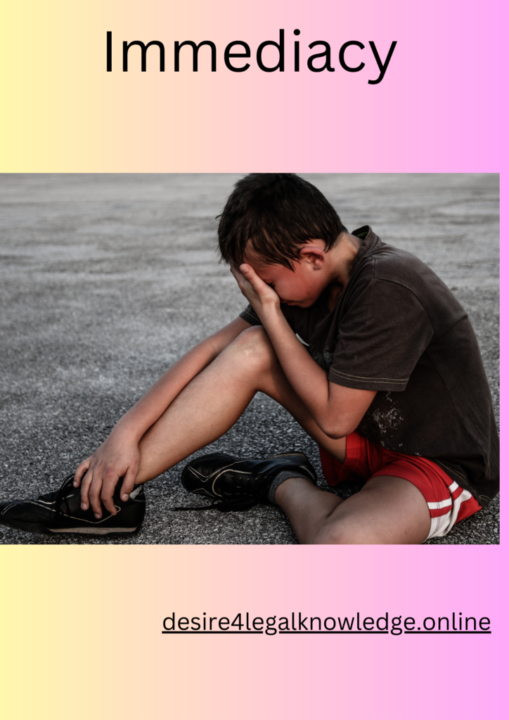 A boy sitting on the ground fearing immediate harm.